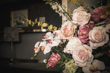 Bouquet of roses in a vase wiht wall.