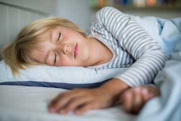 Boy sleeping on bed in the bedroom
