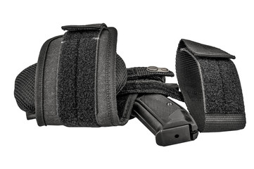The gun in the tactical on-shin holster. Isolated