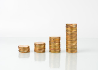 stacks of golden coins on white background