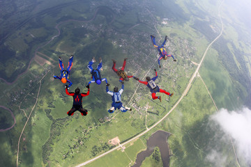 Obraz premium A group of skydivers is in the sky.