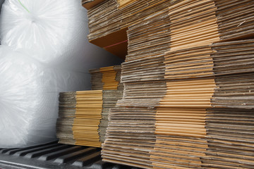 corrugated cardboard box flattened stacked and the air bubbles protection in trucks ready to deliver