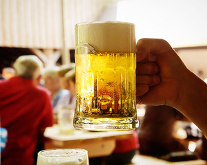 Drinking beer  in one of the many open air restaurant called 