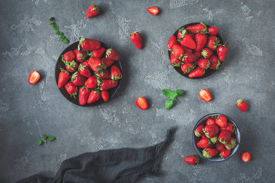 Strawberry in the plate. Fresh strawberry on black background. Flat lay, top view