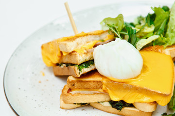 Beautiful fresh Croque-Madame. Sandwich with cheese and ham on the grill, a popular French Breakfast