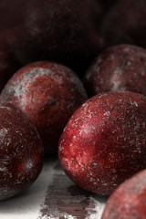 Red passion fruits on old wood background.