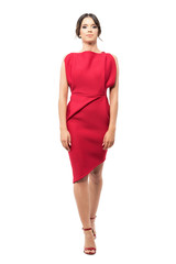Walking young elegant woman in red evening dress looking at camera.  Full body length portrait...