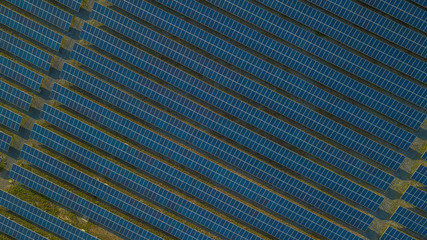 Aerial view of solar panels in solar farm for green energy from drone.