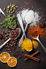 Various spices spoons on stone table