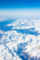 Fototapeta na wymiar Snow Alps - aerial view from window of airplane