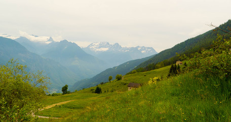 Mountain landscape with a house in the Swiss alps in the summer.
