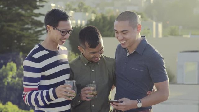 Group Of Gay Friends Take A Photo Together At Sunset On A Rooftop In San Francisco 