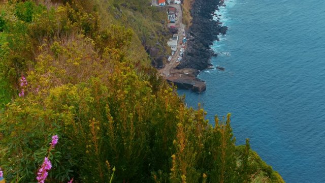 Establishing shot of the Farol Ponta do Arnel lighthouse in the Nordeste city, Sao Miguel, The Azores, Portugal