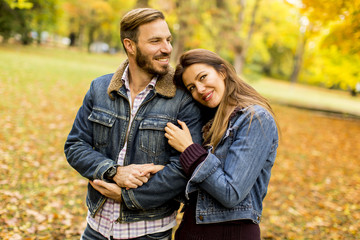 Fototapeta premium Smiling couple hugging in autumn park