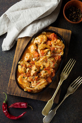 Chakhokhbili - traditional Georgian dish. Stewed chicken with tomato, onion, garlic, pepper and cilantro. Selective focus. Top view.