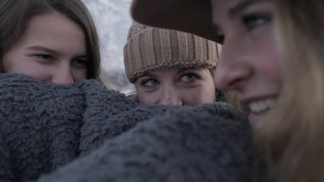 Teen Girls Warm Up With Cozy Blanket, They Hide Behind It And Peek Out Over It