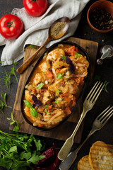 Chakhokhbili - traditional Georgian dish. Stewed chicken with tomato, onion, garlic, pepper and cilantro. Selective focus. Top view.