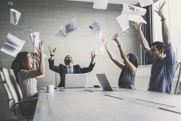 business team throwing paper when meeting success with happy emotion together, people with...