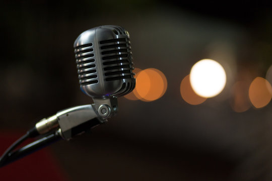 Silver microphone with bokeh background