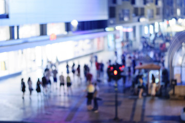 Blurred shop and people in public night market with bokeh