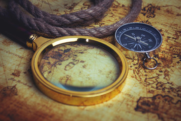 Image of map, magnifying glass and old compass