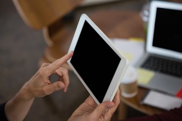 Businesswoman using tablet computer in office