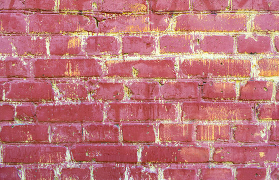 Pink purple old brick wall with paint, background texture close up