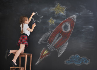 child drawing stars and rocket