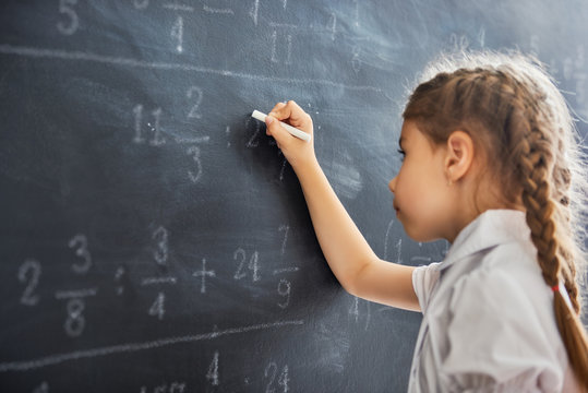 child near the blackboard