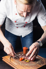 male cooks preparing meals in restaurant kitchen