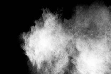 White color powder explosion on black background. Mauve white color cloud.  Freeze motion painted Holi.