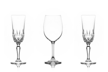 One wine glass and one champagne glass to each side on white background