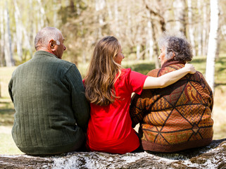 Elderly couple and young caregiver