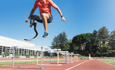 Disabled man athlete training with leg prosthesis.