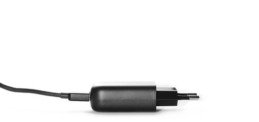 Black electric USB phone charger, plug isolated on white background