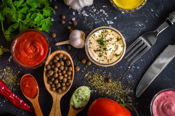 Different sauces on a wooden background
