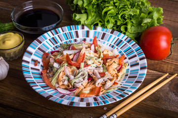 Colored Tagliatelle with vegetables on a wooden background