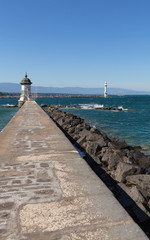 Lighthouse on lake Leman, stone embankment. Geneva Switzerland