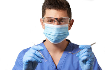 Studio Portrait Of Dentist With Mask Against White Background
