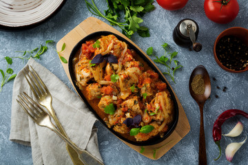 Chakhokhbili - traditional Georgian dish. Stewed chicken with tomato, onion, garlic, pepper and cilantro. Selective focus. Top view.