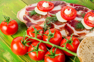 Slices of ham Serrano, dill branches and tomatoes, slices bread.