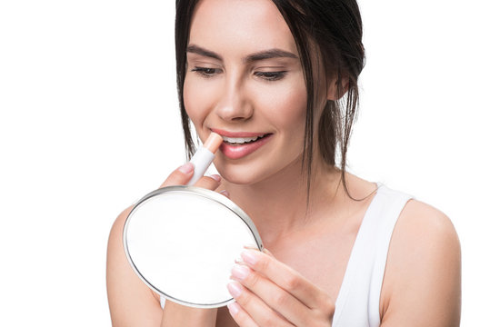 Pretty Young Woman Applying Chapstick On Lips