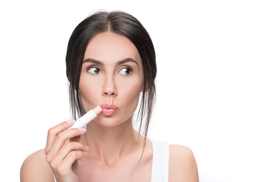 Pretty Brunette Woman Using Chapstick