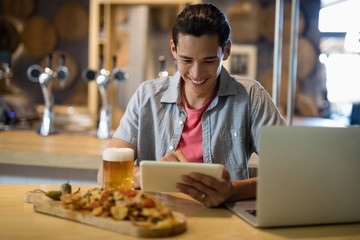 Man using digital tablet in restaurant