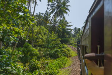 Obraz premium In the railroad car on the way to Galle. Plenty of people are useing the train. Tickets are cheap. The coastal line is a major railway line in Sri Lanka, running between Colombo Fort and Matara