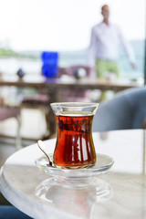 Turkish tea with authentic glass cup on a table in a coffee bar