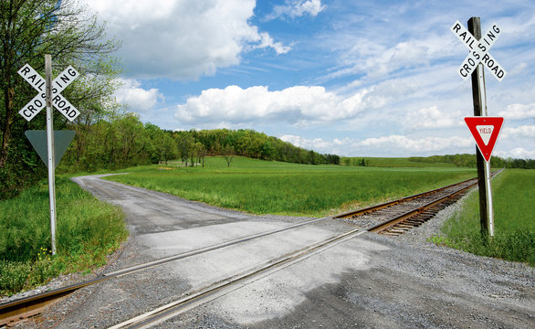 Country Railroad Crossing:  A narrow gravel road crosses a set of railroad tracks in rural Virginia.
