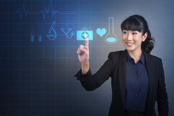 Beautiful Business Woman touching medical technology sign on virtual screen
