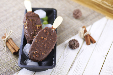 Dessert chocolate ice cream with nuts on wooden stick