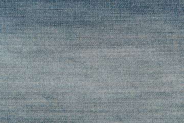 Light blue worn denim jeans fabric texture for background or concept